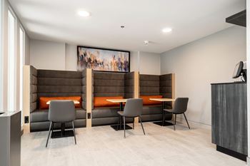 a seating area in a room with tables and chairs